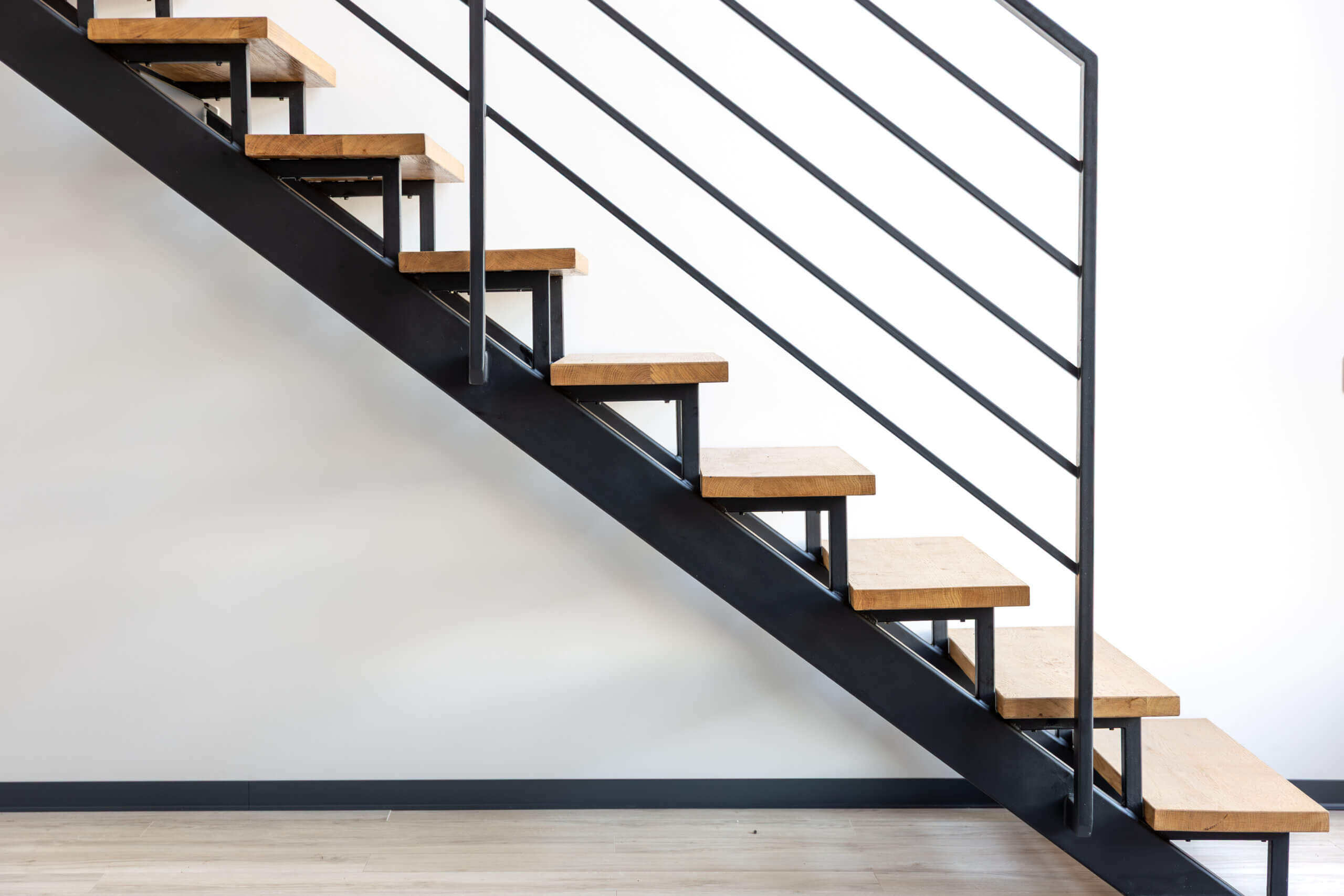 Loft style staircase. Black steel and wood. Geometric architecture.